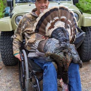 Man in wheelchair turkey hunting